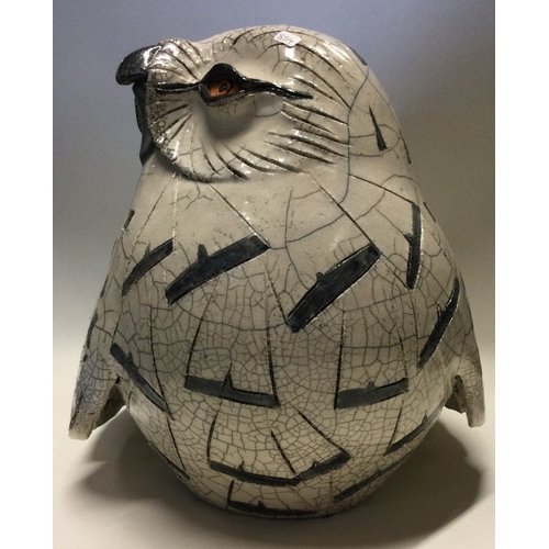 854 - JENNY HALE: A large pottery model of a snowy owl of stylised form. Est. £100 - £200.