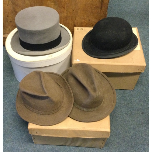 857 - Four boxed top hats. Est. £40 - £60.