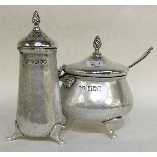 87 - A heavy silver two piece cruet set of stylised form. Approx. 179 grams. Est. £50 - £80.