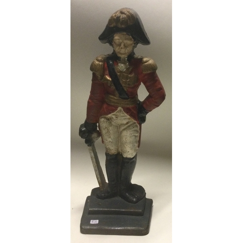 876 - A heavy cast iron door stop in the form of a soldier. Est. £20 - £30.