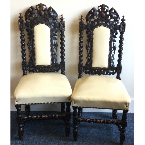 887 - A good pair of carved oak hall chairs. Est. £30 - £40.