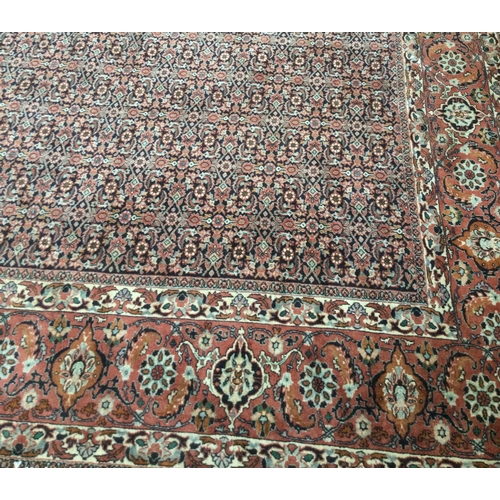 901 - A good large patterned carpet decorated in bright colours. Approx. 353 cms x 258 cms. Est. £100 - £1... 