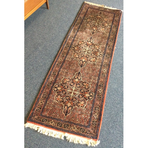 902 - A good quality runner in red ground decorated in bright colours. Approx. 74 cms x 110 cms Est. £40 -... 