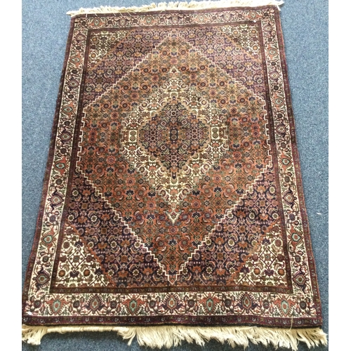 903 - A good quality small rug decorated in bright colours. Approx. 160 cms x  113 cms. Est. £50 - £80.