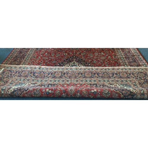 916 - A good large red ground carpet with tassel decoration. Approx. 190 cms x 380 cms. Est. £200 - £300.