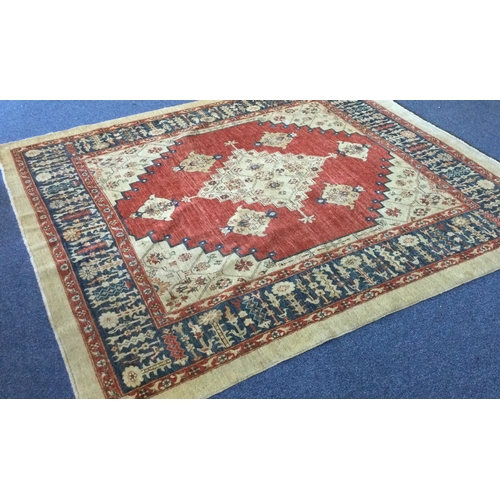 918 - A large square rug in bright colours with central medallion. Approx. 241 cms x 241 cms. Est. £70 - £... 