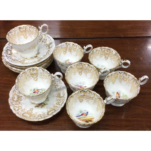 921 - A set of seven Coalport Adelaide shape cups and saucers decorated with birds. Pattern number 4385. E... 