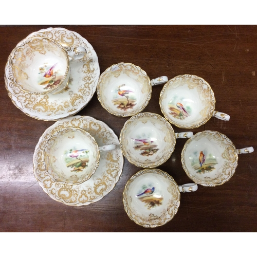 921 - A set of seven Coalport Adelaide shape cups and saucers decorated with birds. Pattern number 4385. E... 