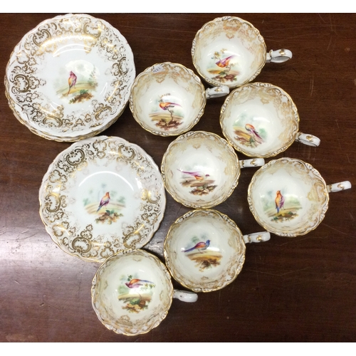 921 - A set of seven Coalport Adelaide shape cups and saucers decorated with birds. Pattern number 4385. E... 