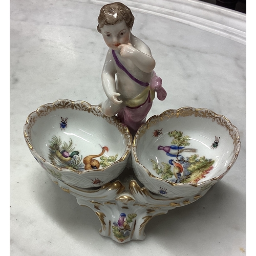 961 - A good Continental porcelain bon bon dish mounted with a figure. Est. £50 - £80.