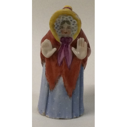 970A - A 19th Century Royal Worcester porcelain candle snuffer; Madame Snow in blue spotty dress. Est. £40 ... 