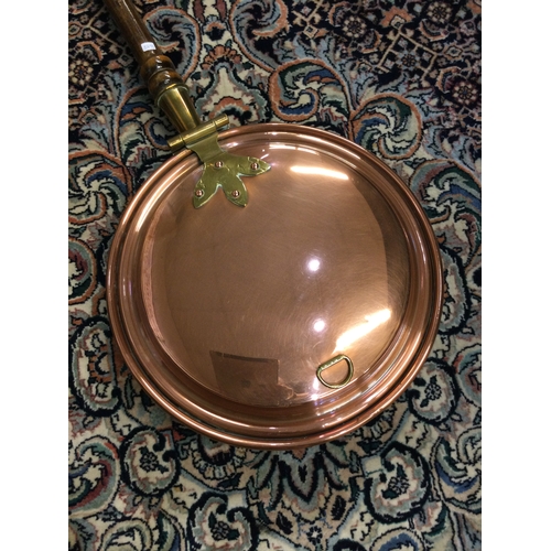 881 - A heavy brass preserve pan together with a copper bed warmer. £20 - £30.