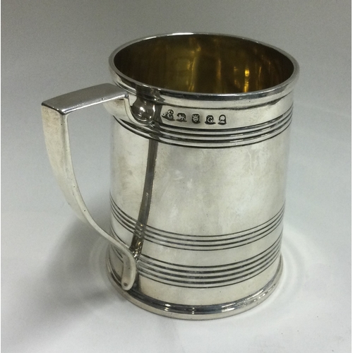 12 - A Georgian silver reeded tankard. London 1802. By John Emes. Approx. 139 grams. Est. £150 - £200.