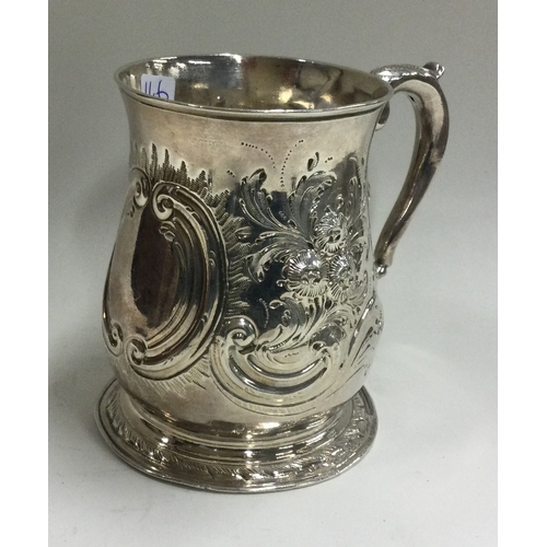 146 - An 18th Century Georgian silver chased mug. Marked to base. Approx. 158 grams. Est. £150 - £200.