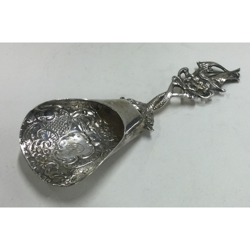 158 - A Continental silver chased caddy spoon. Approx. 31 grams. Est. £50 - £80.