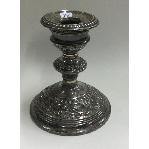 168 - A heavy silver candle holder with embossed decoration. Birmingham. Approx. 357 grams of gross weight... 