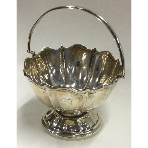 174 - A small silver swing handled basket of shaped form. Birmingham. Approx. 47 grams. Est. £30 - £50.