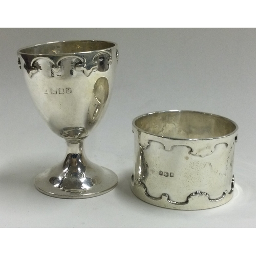 181 - An Art Deco silver egg cup and napkin ring set. London 1916. Approx. 70 grams. Est. £60 - £80.