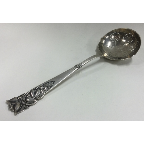 189 - A large silver ladle with pierced and chased handle. Approx. 79 grams. Est. £50 - £80.