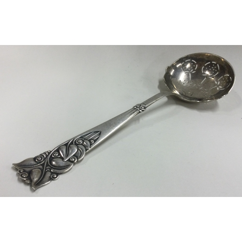 189 - A large silver ladle with pierced and chased handle. Approx. 79 grams. Est. £50 - £80.