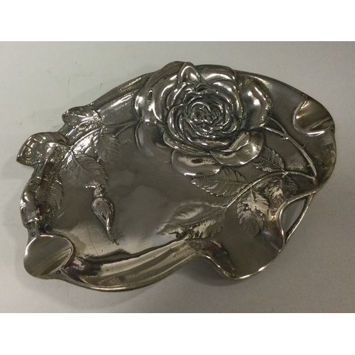 228 - A novelty silver dish embossed with flowers and engraved with vines. Marked to interior. Approx. 125... 