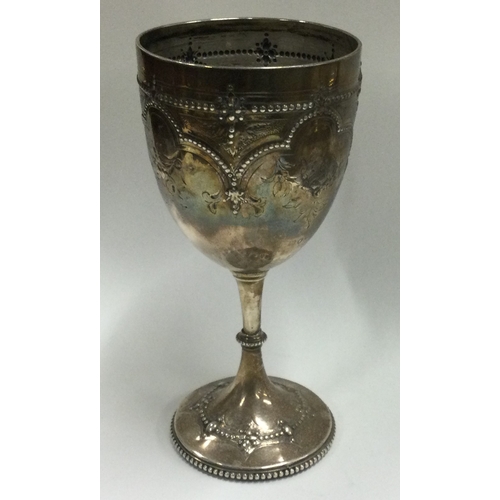 242 - A Victorian silver chased goblet. London 1874. Approx. 148 grams. Est. £150 - £200.