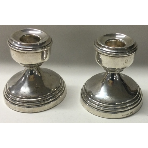 245 - A pair of silver candlesticks. Birmingham 1964. Approx. 280 grams. Est. £40 - £60.