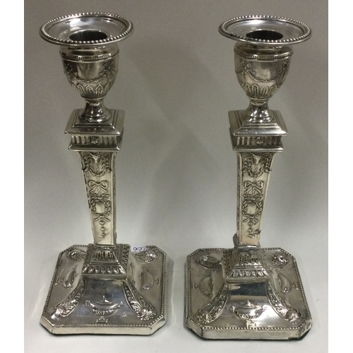 266 - A pair of Neoclassical silver candlesticks. Approx. 601 grams. Est. £300 - £500.