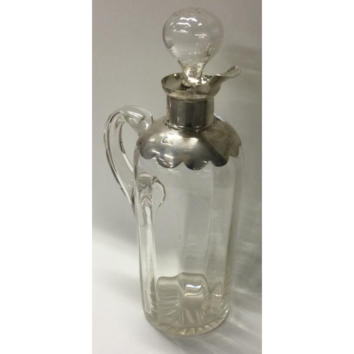 276 - A large silver and glass whisky jug and stopper. London 1902. By William Comyns. Est. £100 - £150.