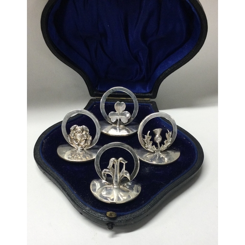 278 - A set of four silver menu holders depicting thistles and flowers. Birmingham 1911. By Horace Woodwar... 