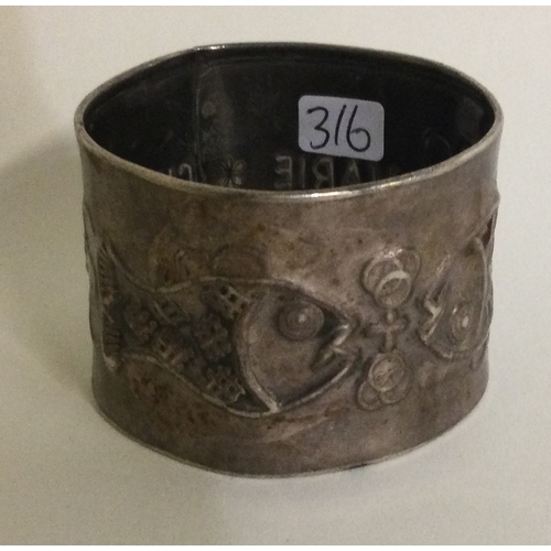 316 - A large Continental silver napkin ring decorated with fish. Marked to interior. Approx. 43 grams. Es... 