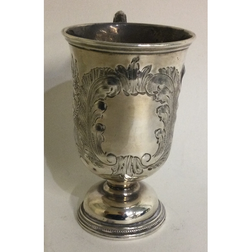 322 - A chased Victorian silver christening mug. Birmingham 1874. By George Unite. Approx. 82 grams. Est. ... 