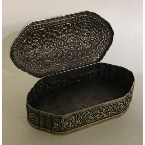 347 - A chased Southern Asia silver hinged snuff box. Approx. 149 grams. Est. £120 - £150.