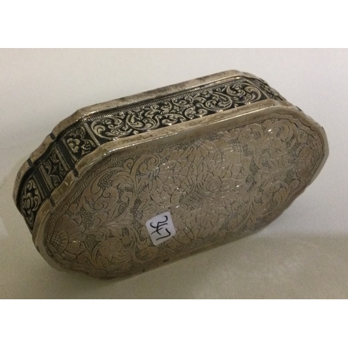 347 - A chased Southern Asia silver hinged snuff box. Approx. 149 grams. Est. £120 - £150.