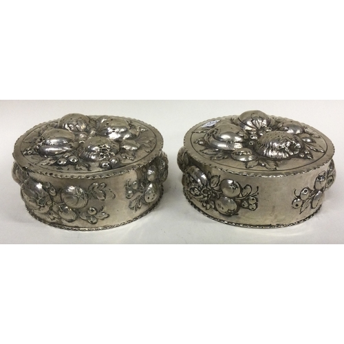 367 - A pair of chased Continental silver Antique boxes. Marked to bases. Approx. 243 grams. Est. £200 - £... 