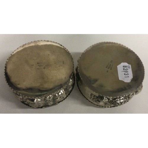 367 - A pair of chased Continental silver Antique boxes. Marked to bases. Approx. 243 grams. Est. £200 - £... 