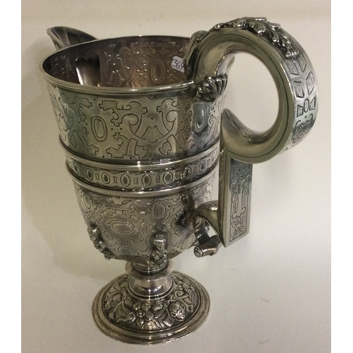 369 - A heavy chased figural Continental silver jug. Marked to body. Approx. 830 grams. Est. £500 - £800.