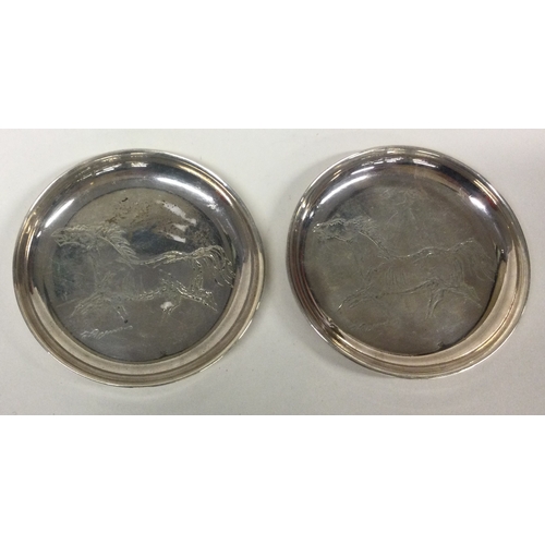 385 - A pair of silver dishes engraved with horses. Signed to base. Approx. 68 grams. Est. £50 - £80.