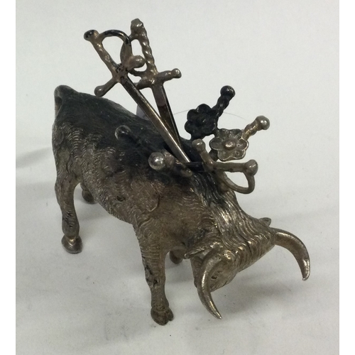 405 - A silver toothpick holder in the form of a cow. Approx. 67 grams. Est. £120 - £150.