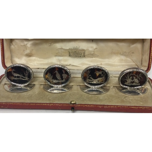 419 - A set of four silver and tortoiseshell inlaid menu holders decorated with birds. London 1913. By Wil... 