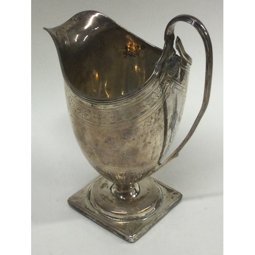 420 - An 18th Century Georgian silver jug with bright cut decoration. Approx. 134 grams. Est. £60 - £80.