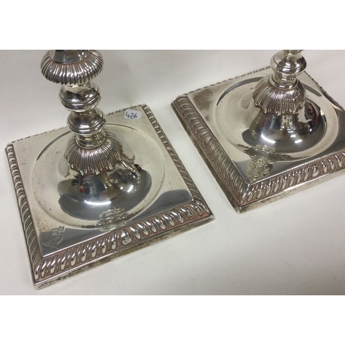 426 - A fine pair of 18th Century Georgian silver candlesticks on square bases. London 1759. By William Ca... 