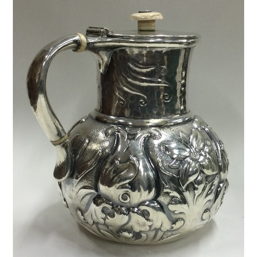 44 - A good 19th Century American silver chased mug with hinged lid bearing import marks. Approx. 742 gra... 