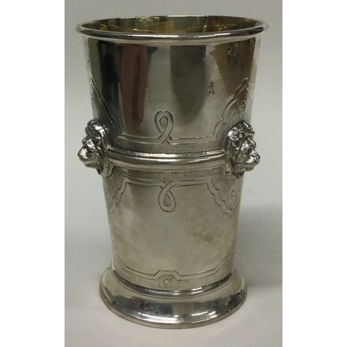 467 - A chased silver beaker embossed with lions. Birmingham 1934. By Barker Brothers Ltd. Approx. 231 gra... 