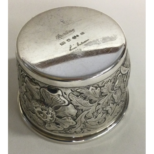 489 - A Continental chased silver beaker. Marked to base. Approx. 56 grams. Est. £50 - £80.