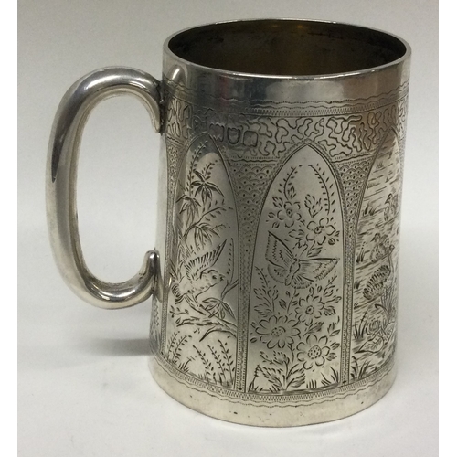 504 - A novelty Victorian silver panelled mug engraved with birds, butterflies, ducks, and spiderwebs. Lon... 