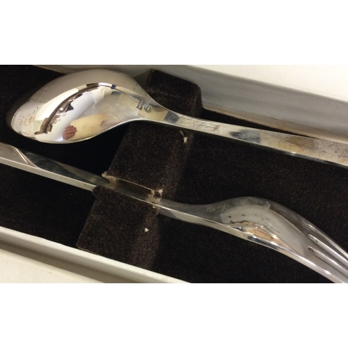 509 - GEORG JENSEN: A cased silver christening spoon and fork. Marked to base. Approx. 199 grams. Est. £10... 