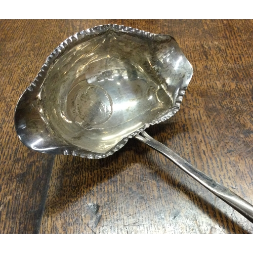 515 - A 19th Century silver toddy ladle with coin centre. Approx. 42 grams. Est. £40 - £60.