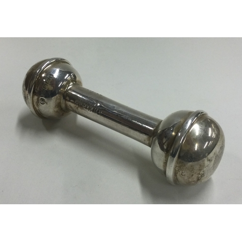 52 - A silver christening baby's rattle in the form of a dumbbell. Engraved weight and date. Birmingham. ... 