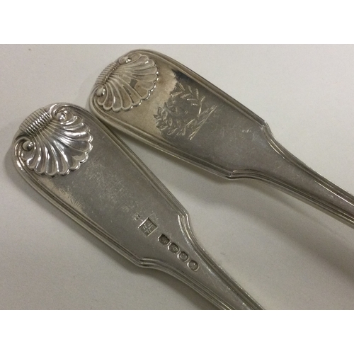 528 - A pair of heavy George III silver basting spoons of fiddle, thread and shell pattern. London 1818. B... 